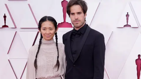 EPA Chloe Zhao and Joshua James Richards at the Oscars