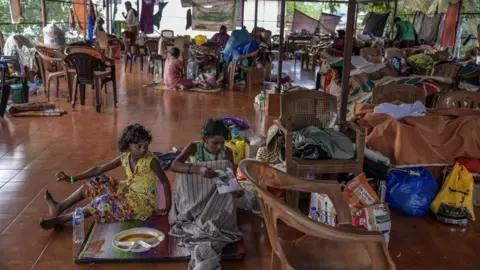 Getty Images Children sitting in a makeshift camp