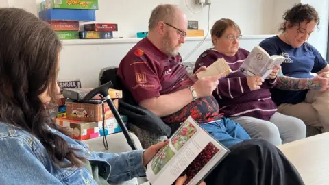 Amanda White/BBC A meeting of the book club at the Brew café bar in Hull