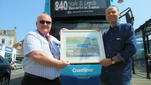 Bus Users UK Paul Kirby (right) presents the award to Transdev's Colin Booth