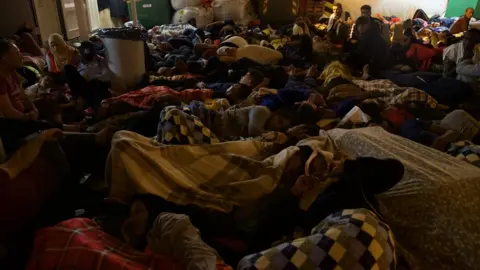 Migrants sleep on board the Vos Prudence