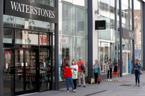 Alamy Live News People queue for books in Altrincham