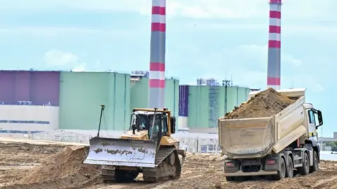Getty Images Lorries and excavators work in the area of the Paks Nuclear Power Plant to prepare the new Paks II construction works on September 10, 2022, in Paks, southern Hungary