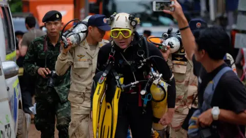 Linh Pham/Getty Images John Volanthen walks out from Tham Luang Nang Non cave in Thailand