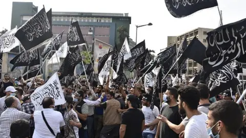 Getty Images People carrying banners gather to protest in Lebanon