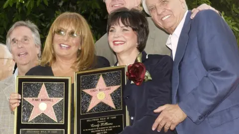 Reuters Holding replica plaques, Penny Marshall (2nd L), and Cindy William pose with (L-R) Henry Winkler, Ed Begley Jr and Garry Marshall at the two-star unveiling ceremony on the Hollywood Walk of Fame on 12 August 2004