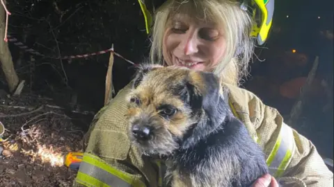 Gloucestershire Fire and Rescue Service  Coco the dog with a member of Gloucestershire Fire and Rescue Service