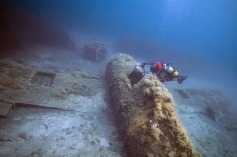 AFP A French military diver member of the FS Pluton M622 navy de-mining ship, swims above the wreck of an USAAF P-47 Thunderbolt (Warthog) US fighter plane