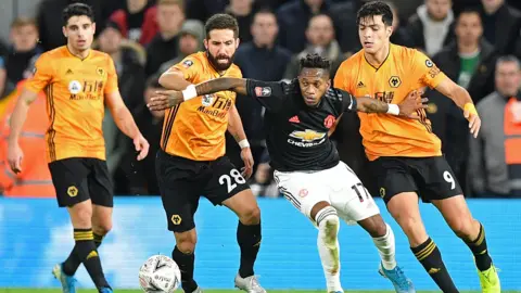 Wolves and Manchester United players battle for possession
