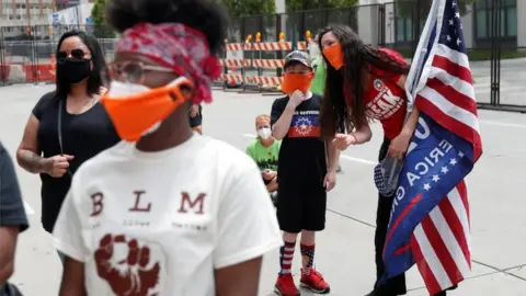 Reuters Trump supporters watch a Juneteenth memorial