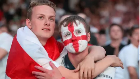 PA Tearful supporters in Manchester