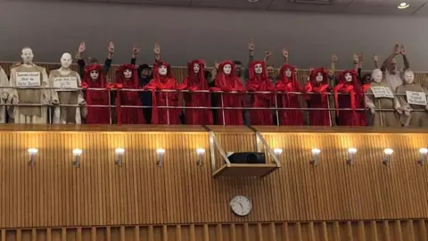 Rob Nolan/Facebook Extinction Rebellion protesters in council chamber gallery. Pic: Rob Nolan