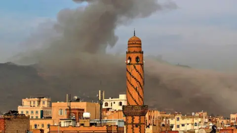 Getty Images Smoke billows following an airstrike by Saudi-led coalition in the Yemeni capital Sanaa earlier this month