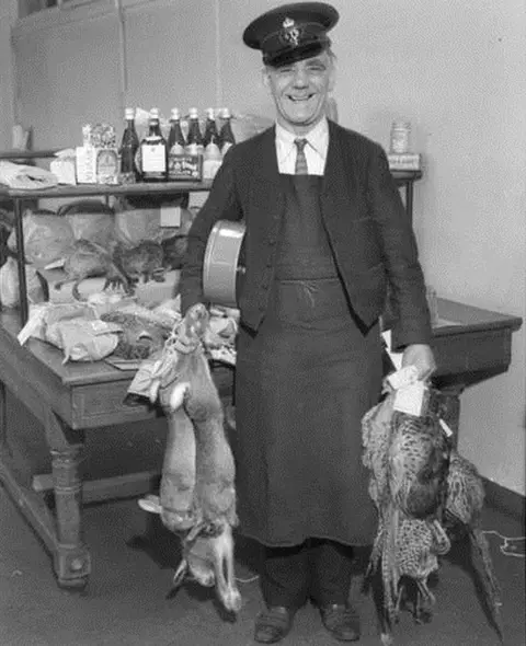 Royal Mail Group Ltd, courtesy The Postal Museum  Postman with rabbits and pheasants