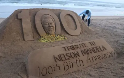 Getty Images Sand sculpture of former president of South Africa Nelson Mandela is seen at the Bay of Bengal Sea's eastern coast beach as it is creating by Indian sand artist Sudarshan Pattnaik for visitors attraction on the occasion of his 100th birth anniversary at Puri, 65 km away from the eastern Indian state odisha's capital city Bhubaneswar, on July 18, 2018.