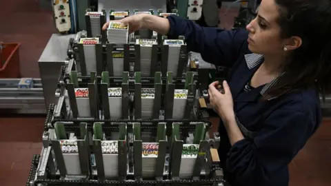 Getty Images A worker prepares packages of stickers at the Panini Group factory in Modena, northern Italy, ahead of the 2018 World Cup in Russia