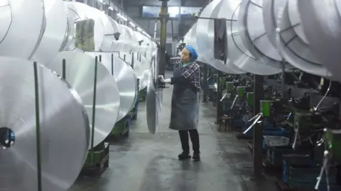 Getty Images An employee handles aluminium material in Hangzhou, Zhejiang Province of China.