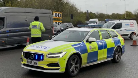 Essex Police Police care by a road in Essex