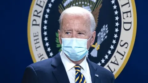 Getty Images US President Joe Biden arrives for a conference call on climate change with the Major Economies Forum on Energy and Climate (MEF)