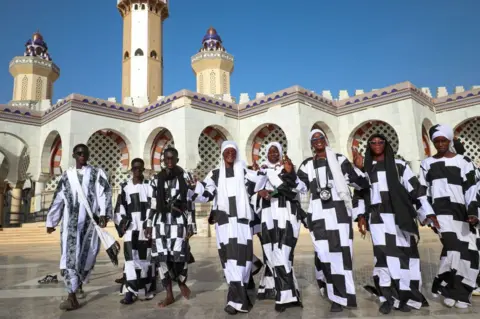 CEM OZDEL/GETTY IMAGES Followers of the Baye Fall movement in Touba.