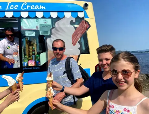 People eating ice creams to cool down at Loch Lomond