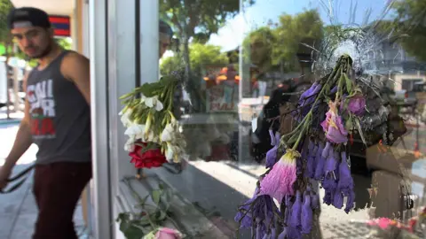Getty Images Flowers fill bullet holes in Isla Vista, California