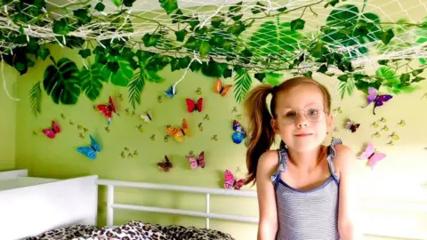 The Eaton Family Aurora Eaton in jungle bedroom