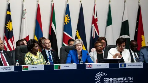 Getty Images Theresa May and other Commonwealth leaders in front of a row of flags