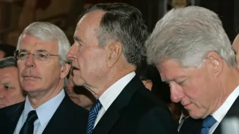Getty Images John Major (L), George HW Bush (C) and Bill Clinton at Boris Yeltsin's funeral in April 2007