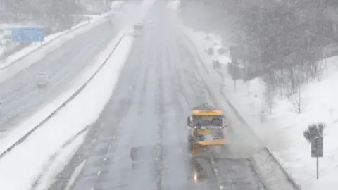 Reuters Snow ploughs on M80