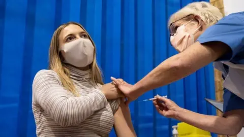 Getty Images Woman receiving vaccine