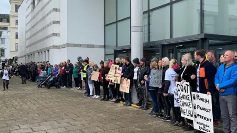 BBC Protestors standing in front of Douglas Courthouse