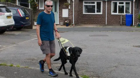 Joanne Stone Jon Petty with his guide dog