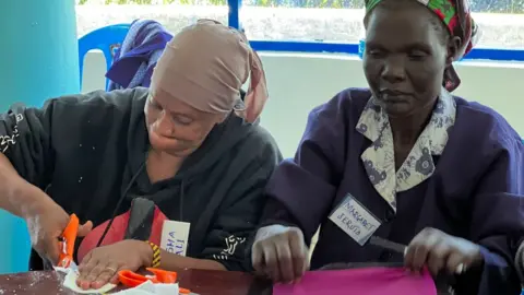 BBC Two women cut up fabric