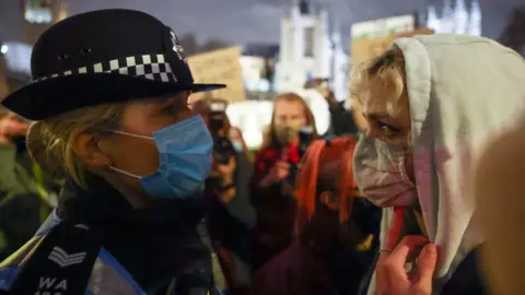 A police woman with a protester