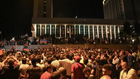 Getty Images Azeri protesters gather outside the national assembly in Baku amid pro-war demonstrations, after deadly border clashes with Armenia