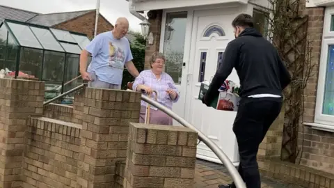 Local Democracy Reporting Service Maguire handing out food hampers