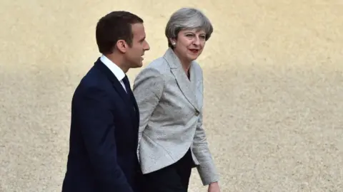 AFP Emmanuel Macron and Theresa May