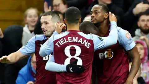 Villa players celebrate a goal