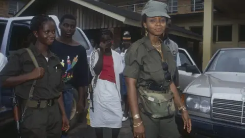 Patrick Robert/Getty Agnes Taylor pictured with a gun