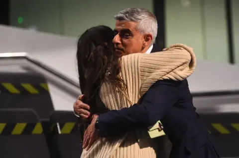 Victoria Jones/PA Media Sadiq Khan is hugged by his daughter after being re-elected Mayor of London in May