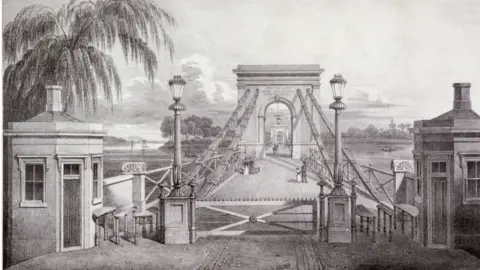 Getty Images View of the entrance to the suspension bridge at Hammersmith, London, 1827.