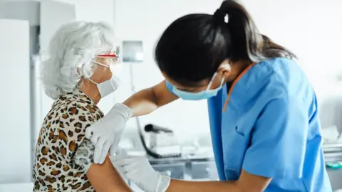 Getty Images Person getting a vaccine