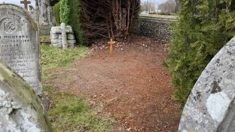 Shaun Whitmore/BBC Ellen Chaloner's grave marked with a wooden cross