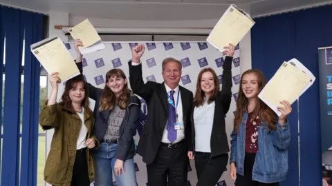 Weston College Dr Paul Phillips with top performing A-level students