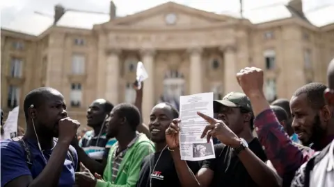 AFP Undocumented migrants demonstrate in front of the Panthéon in Paris to ask for the regularisation of their situation