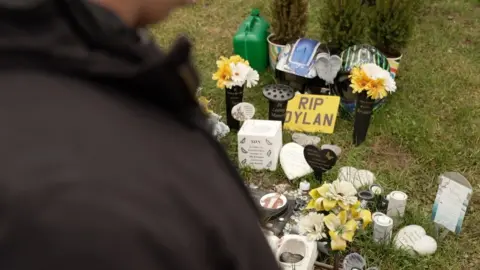 Ant Saddington/BBC A shrine at the spot where Dylan Holliday was stabbed