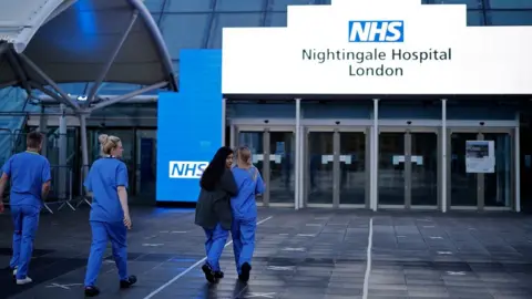 Getty Images Staff outside NHS Nightingale in London