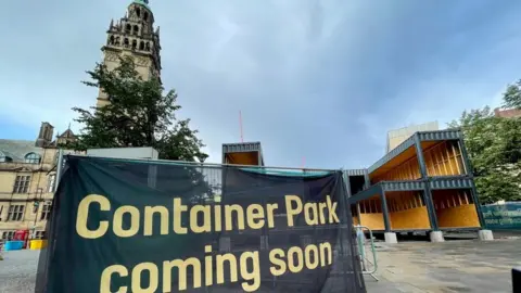 LDRS Image of a sign saying 'coming soon' at the container park site
