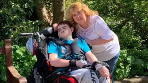 Leigh Day Cameron Mitchell (L) and his mother, Nicola Clulow